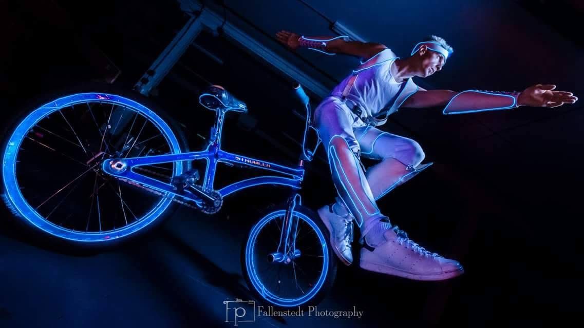 Blake Hicks flying off the blue EL-wire bike