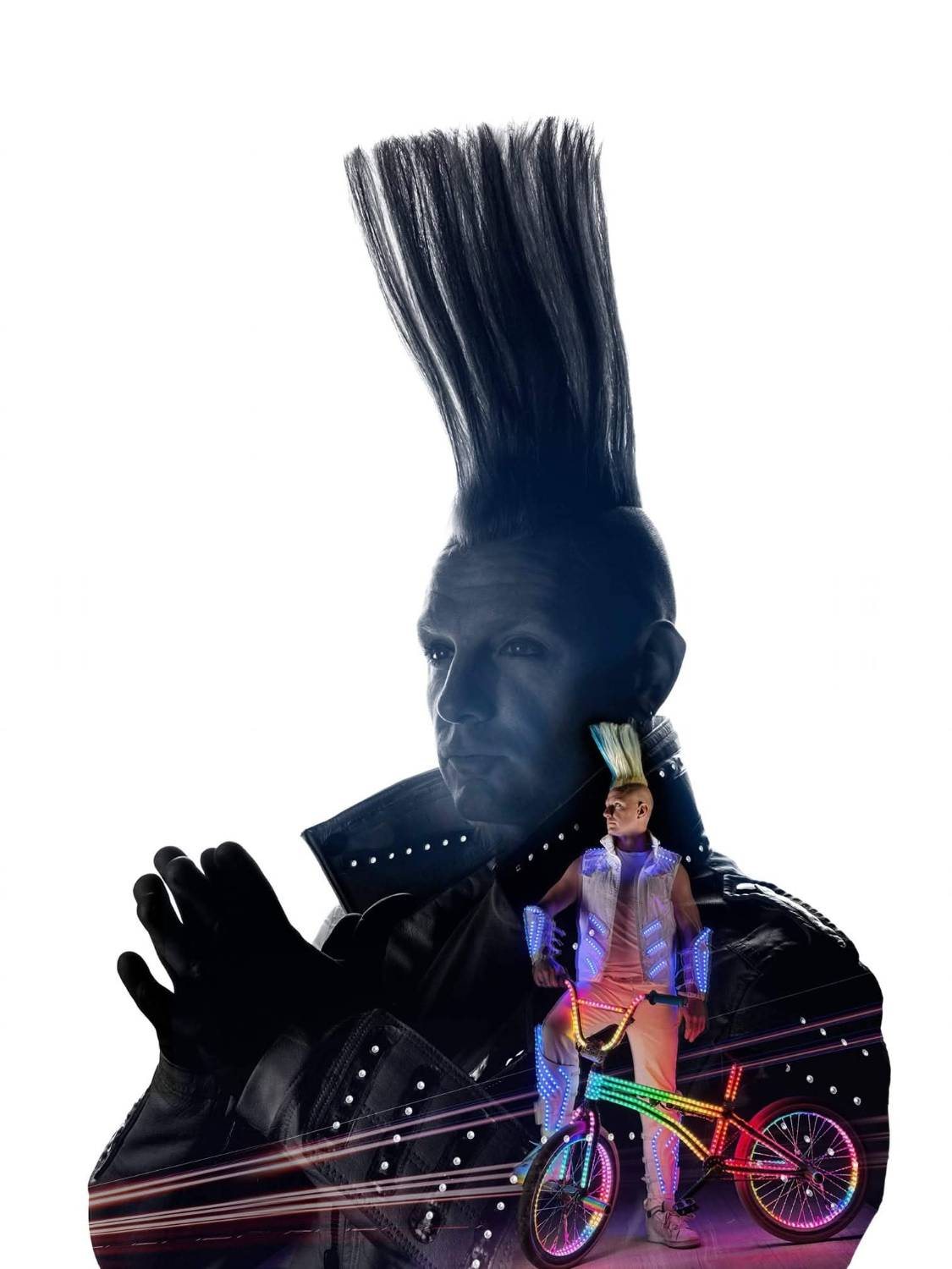 Portrait of Blake Hicks with his tall mohawk, with him standing in an LED suit beside the rainbow LED bike inset