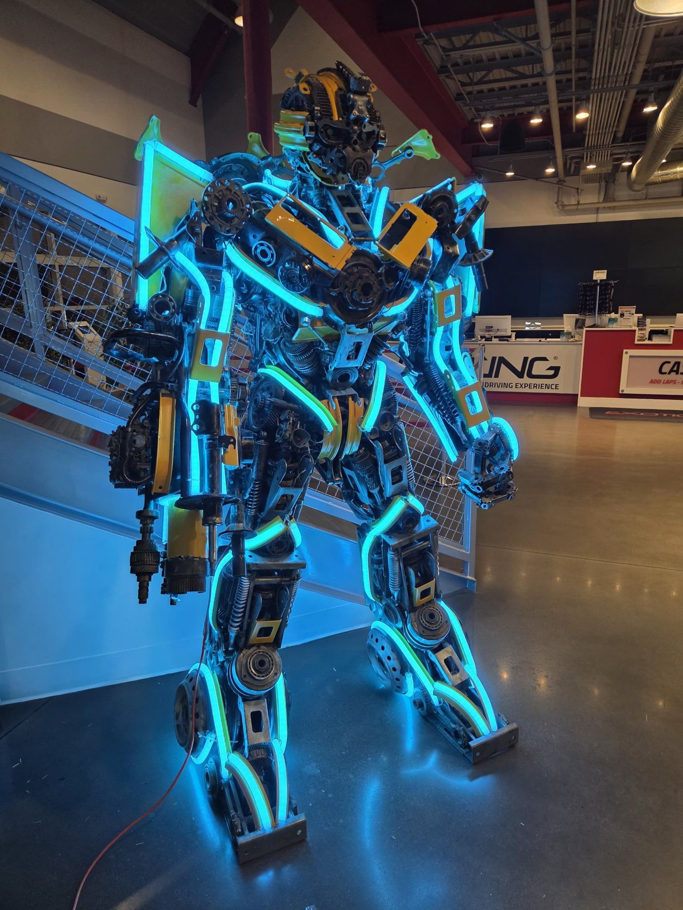 Scrap-metal robot sculpture with its LED neon set to ice blue