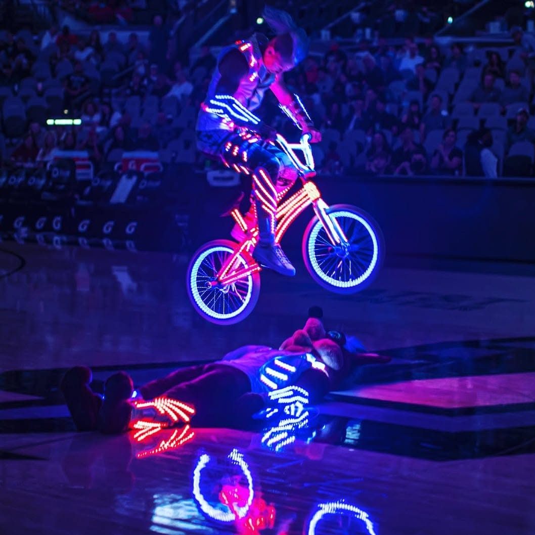 Blake Hicks jumping the LED bike over the Spurs Coyote